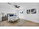 Bright bedroom featuring light wood floors, a ceiling fan, and modern gray and white decor at 3630 Tobias Ln, Las Vegas, NV 89120