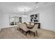 Bright dining room featuring a chandelier, large table with seating for eight, and light wood floors at 3630 Tobias Ln, Las Vegas, NV 89120