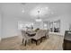 Bright dining room featuring a chandelier, large table with seating for eight, and light wood floors at 3630 Tobias Ln, Las Vegas, NV 89120