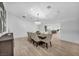 Bright dining room featuring a chandelier, large table with seating for eight, and light wood floors at 3630 Tobias Ln, Las Vegas, NV 89120
