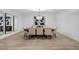 Bright dining room with a modern chandelier, large table with seating for eight, and light wood floors at 3630 Tobias Ln, Las Vegas, NV 89120