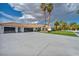 Stately home with a tile roof, black garage doors, expansive driveway and lush landscaping at 3630 Tobias Ln, Las Vegas, NV 89120