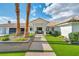Home facade featuring lush landscaping, stone accents, and a tiled roof at 3630 Tobias Ln, Las Vegas, NV 89120