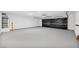Spacious garage with epoxy flooring, ample room for multiple vehicles, and storage options at 3630 Tobias Ln, Las Vegas, NV 89120
