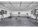 Spacious home gym with exercise equipment and black rubber flooring for a complete workout experience at 3630 Tobias Ln, Las Vegas, NV 89120