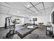 Well-equipped home gym with natural light and massage tables, providing a versatile fitness space at 3630 Tobias Ln, Las Vegas, NV 89120
