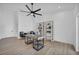 Spacious home office with a modern desk, built-in bookshelves, and a ceiling fan at 3630 Tobias Ln, Las Vegas, NV 89120