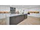 Modern kitchen with a large island, sleek white cabinets, and stainless steel appliances for cooking and entertaining at 3630 Tobias Ln, Las Vegas, NV 89120