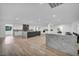 Open-concept kitchen with marble countertops, a wine fridge, and stainless steel appliances at 3630 Tobias Ln, Las Vegas, NV 89120