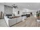 Large open living space featuring a modern fireplace, comfortable seating, and gourmet kitchen at 3630 Tobias Ln, Las Vegas, NV 89120