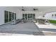 An expansive covered patio with stylish seating areas for entertaining guests with great lighting at 3630 Tobias Ln, Las Vegas, NV 89120