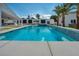 Stunning backyard pool with clear blue water, surrounded by a patio and lush landscaping at 3630 Tobias Ln, Las Vegas, NV 89120