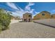 Spacious backyard with gravel, surrounded by a white fence at 3636 Remington Grove Ave, North Las Vegas, NV 89081