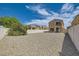 Backyard with gravel ground cover, white fence and covered patio at 3636 Remington Grove Ave, North Las Vegas, NV 89081