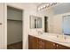 Bathroom featuring a double vanity, a walk-in closet, and a separate toilet area at 3636 Remington Grove Ave, North Las Vegas, NV 89081