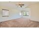 Spacious bedroom with neutral carpet, vaulted ceilings and a ceiling fan for added comfort at 3636 Remington Grove Ave, North Las Vegas, NV 89081