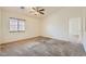 This bedroom has a ceiling fan, window with blinds, and an open doorway at 3636 Remington Grove Ave, North Las Vegas, NV 89081