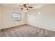 Carpeted bedroom with a ceiling fan and bright, neutral walls and light from the window at 3636 Remington Grove Ave, North Las Vegas, NV 89081