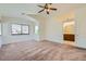 Large bedroom with carpet, natural light, ceiling fan and en-suite bathroom entrance at 3636 Remington Grove Ave, North Las Vegas, NV 89081