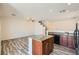 Open-concept area combines kitchen island with seating, sink, appliances and large living space at 3636 Remington Grove Ave, North Las Vegas, NV 89081