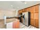 Modern kitchen featuring an island with granite countertops, wood cabinets and stainless appliances at 3636 Remington Grove Ave, North Las Vegas, NV 89081