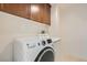 Bright laundry room features modern washer and dryer with overhead cabinets at 3636 Remington Grove Ave, North Las Vegas, NV 89081