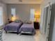 Bright bedroom with two twin beds, neutral walls, and tiled floor at 3720 Rocklin Peak Ave, North Las Vegas, NV 89081