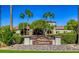 Inviting clubhouse with lush landscaping, mature palms, and appealing architectural details at 3720 Rocklin Peak Ave, North Las Vegas, NV 89081