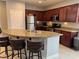 Modern kitchen featuring granite countertops, stainless steel appliances, and a breakfast bar at 3720 Rocklin Peak Ave, North Las Vegas, NV 89081