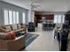 Open living room features tile floors, large windows with shutters, and flows into the kitchen at 3720 Rocklin Peak Ave, North Las Vegas, NV 89081
