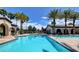 Outdoor pool with lush landscaping and an adjacent lounge and seating area at 3720 Rocklin Peak Ave, North Las Vegas, NV 89081