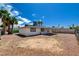 A vast backyard offers rock landscaping, mature trees, and a covered patio at 4484 Bennett Dr, Las Vegas, NV 89121