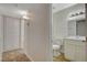 A neutral bathroom features modern vanity, mirror, and lighting near open doorway at 4484 Bennett Dr, Las Vegas, NV 89121