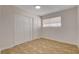 A comfortable bedroom exhibits neutral walls, tile flooring, a window and a closet at 4484 Bennett Dr, Las Vegas, NV 89121