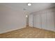 An ample bedroom displays neutral walls, tile flooring and a spacious double closet at 4484 Bennett Dr, Las Vegas, NV 89121