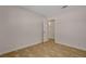 A compact bedroom features tile flooring, neutral walls, an open door, and modern lighting at 4484 Bennett Dr, Las Vegas, NV 89121
