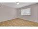 Cozy bedroom featuring neutral walls, tile flooring, and a window bringing in natural light creating a relaxing atmosphere at 4484 Bennett Dr, Las Vegas, NV 89121