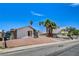 A single-story home with gravel yard, palm trees, and a view of the street at 4484 Bennett Dr, Las Vegas, NV 89121