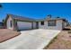 A single-story home featuring an attached garage, gravel yard, and a long driveway at 4484 Bennett Dr, Las Vegas, NV 89121