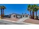 Single-story home featuring a gravel yard, palm trees, and a driveway leading to an attached garage at 4484 Bennett Dr, Las Vegas, NV 89121