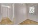 Hallway with white walls, tile floor, built in shelves, and a front door with a diamond pattern glass pane at 4484 Bennett Dr, Las Vegas, NV 89121