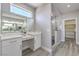 Bright bathroom with double sinks and a vanity area, with a walk-in shower behind a glass partition at 4781 Stoneham, Pahrump, NV 89061