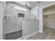 Modern bathroom features a glass-enclosed shower with marble tiles, a window and a shower niche at 4781 Stoneham, Pahrump, NV 89061