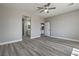 Spacious bedroom with a ceiling fan, gray walls and views of ensuite bathroom and doorway at 4781 Stoneham, Pahrump, NV 89061