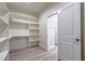 Bright walk-in closet features built-in shelving and grey wood-look floors at 4781 Stoneham, Pahrump, NV 89061