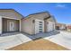 Close-up view of a modern home's entrance and spacious three-car garage at 4781 Stoneham, Pahrump, NV 89061