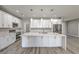 Bright kitchen features white cabinets, stainless appliances and a large quartz island at 4781 Stoneham, Pahrump, NV 89061