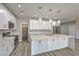 Bright kitchen with white cabinets, stainless appliances and a large island and walk-in pantry at 4781 Stoneham, Pahrump, NV 89061