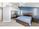 Comfortable bedroom showcases a bed with under-bed storage, complemented by a built-in mirrored wardrobe and a blue accent wall at 4878 Califa Dr, Las Vegas, NV 89122