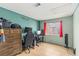 Bedroom featuring hardwood floors, a window with red curtains, and a teal accent wall at 4878 Califa Dr, Las Vegas, NV 89122